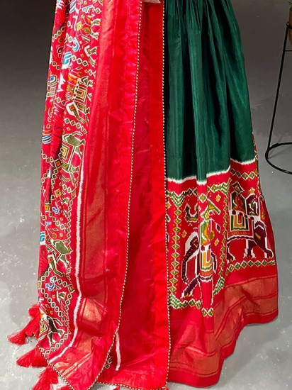 Stunning Dark-Green Patola Print Dola Silk Festive Gown